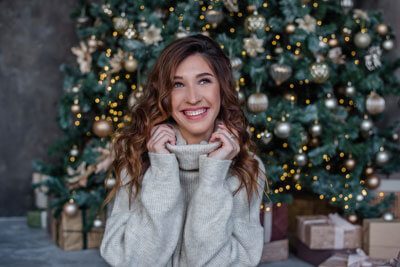 Woman with beautiful smile near a Christmas tree
