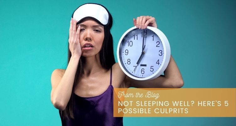 Tired woman holding clock.