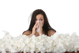 Woman blowing nose with tissue