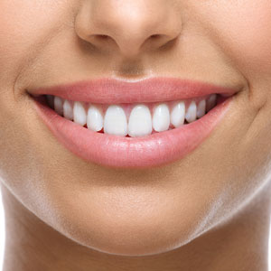 close up of womans beautiful straight white teeth