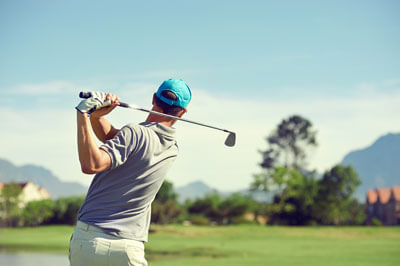 Golfer in bright blue hat
