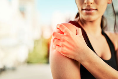 Woman with intense shoulder pain