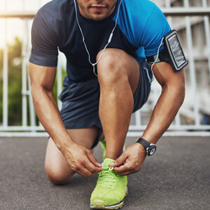 man tying shoe laces ready for a run