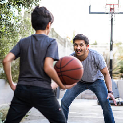 son and dad playing basketball