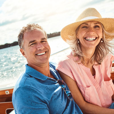 Man and woman smiling while on a boat