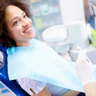 women at dental visit smiling