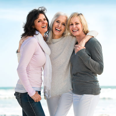 Smiling middle-age ladies on beach
