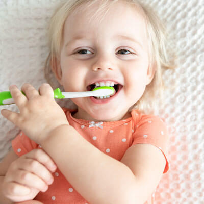 Cute girl brushing teeth