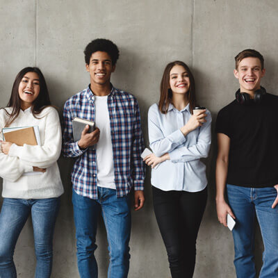 Teens standing against a wall